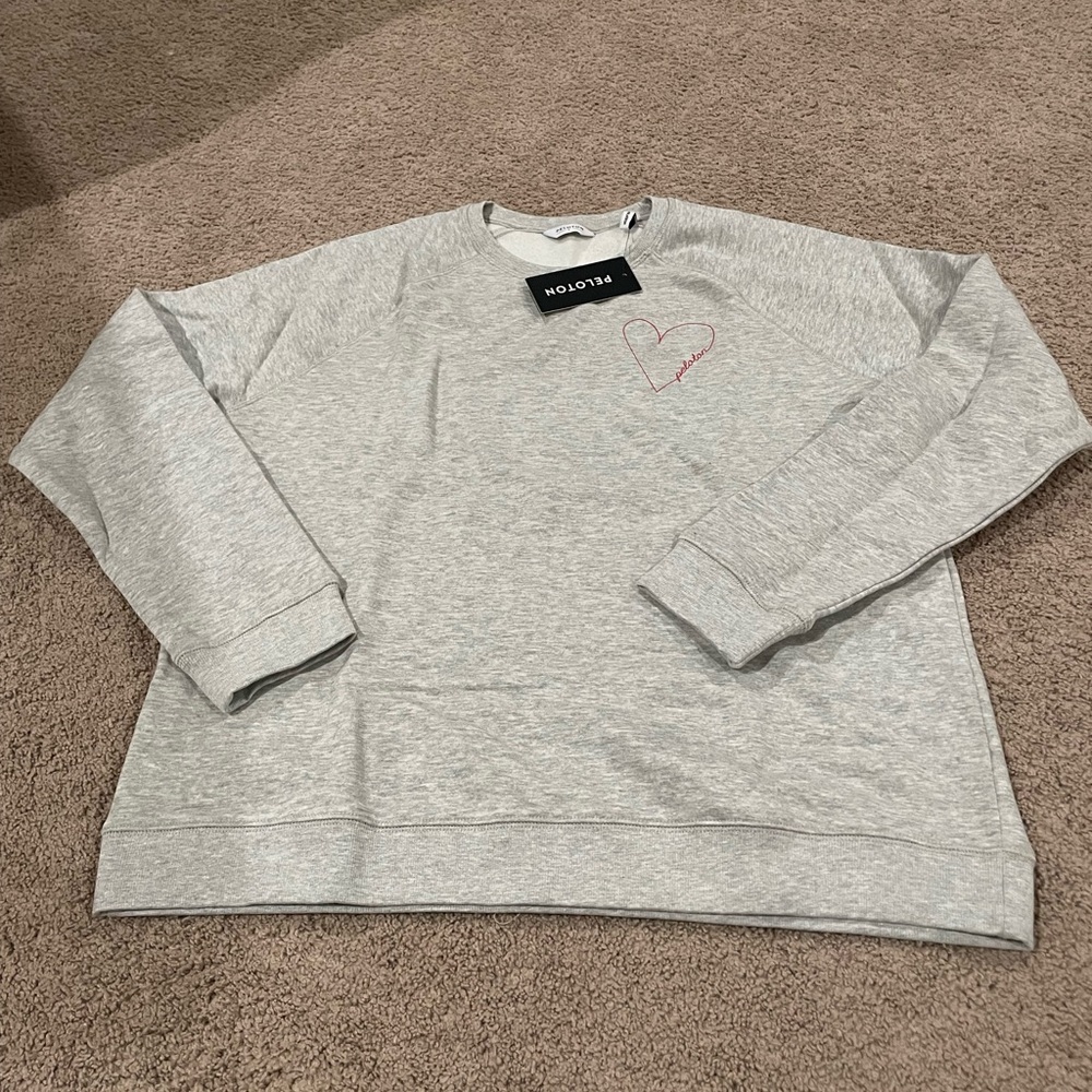 Peloton grey fleece, warm unwind crewneck sweater. Light grey. NWT in bag.